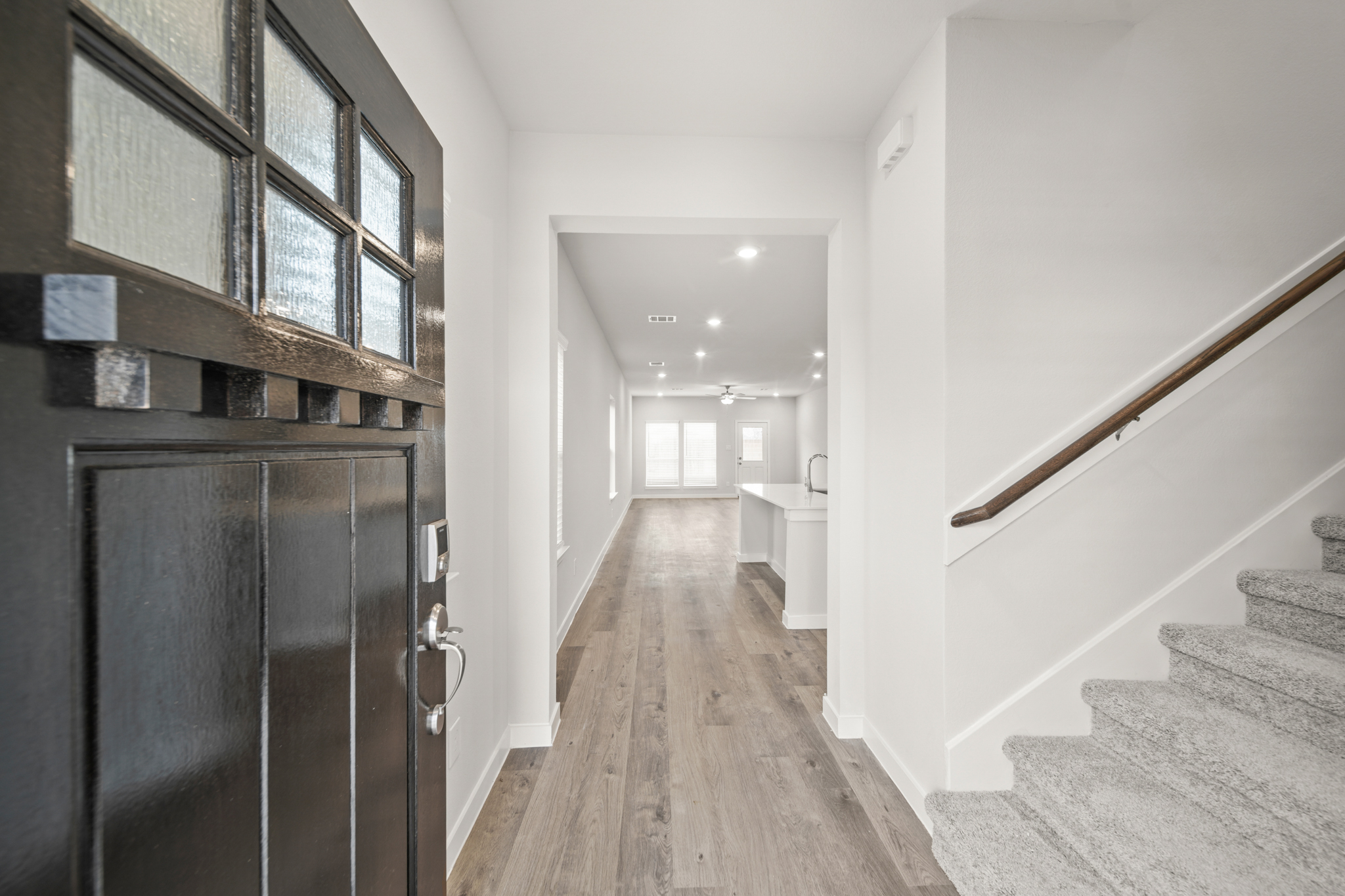 A hallway with a wood floor.