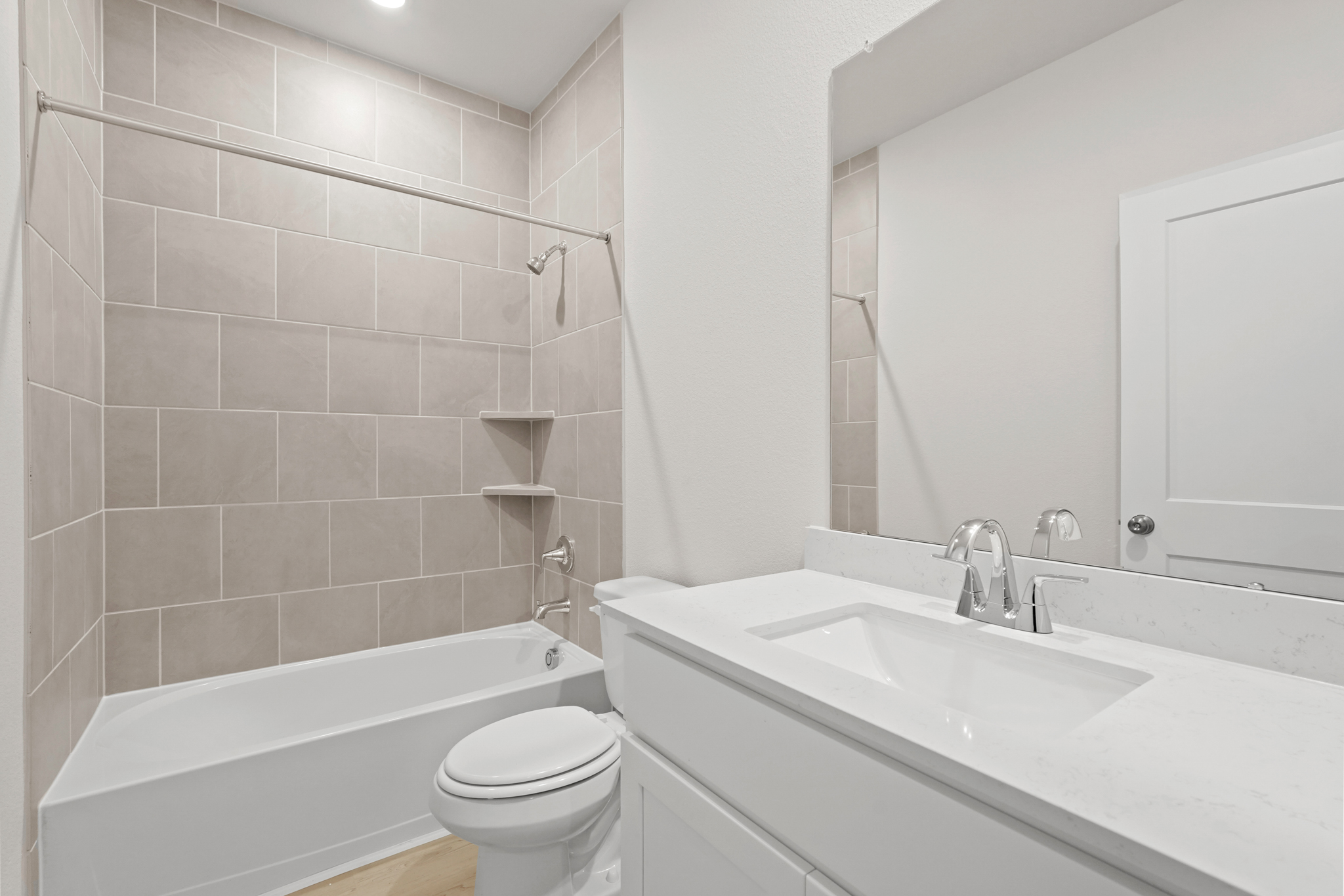 A bathroom with a tub sink and toilet.