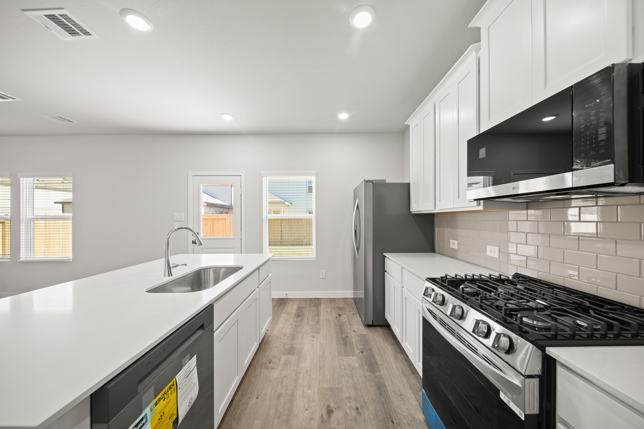 A kitchen with white cabinets.