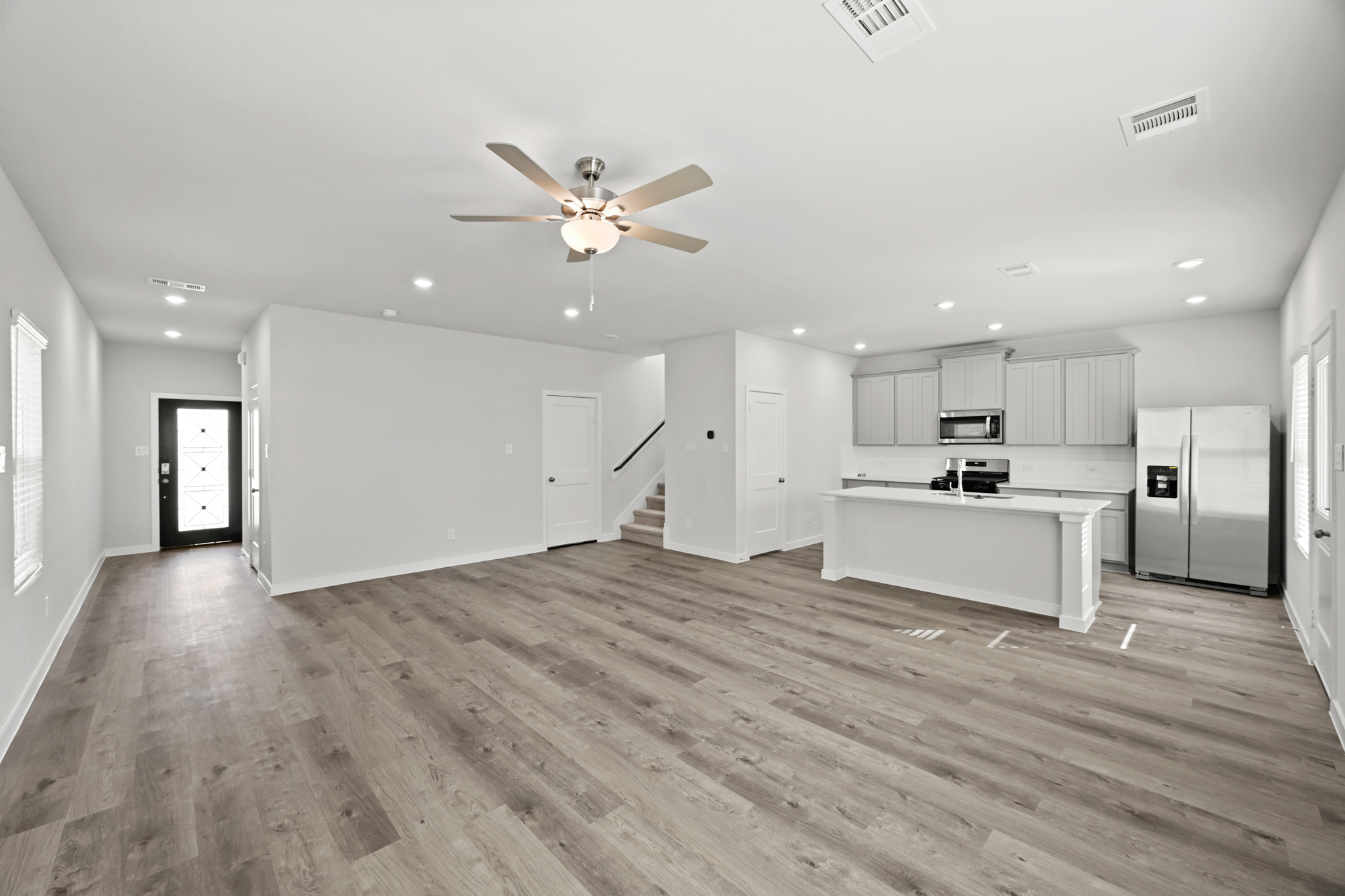 A large kitchen with white cabinets.