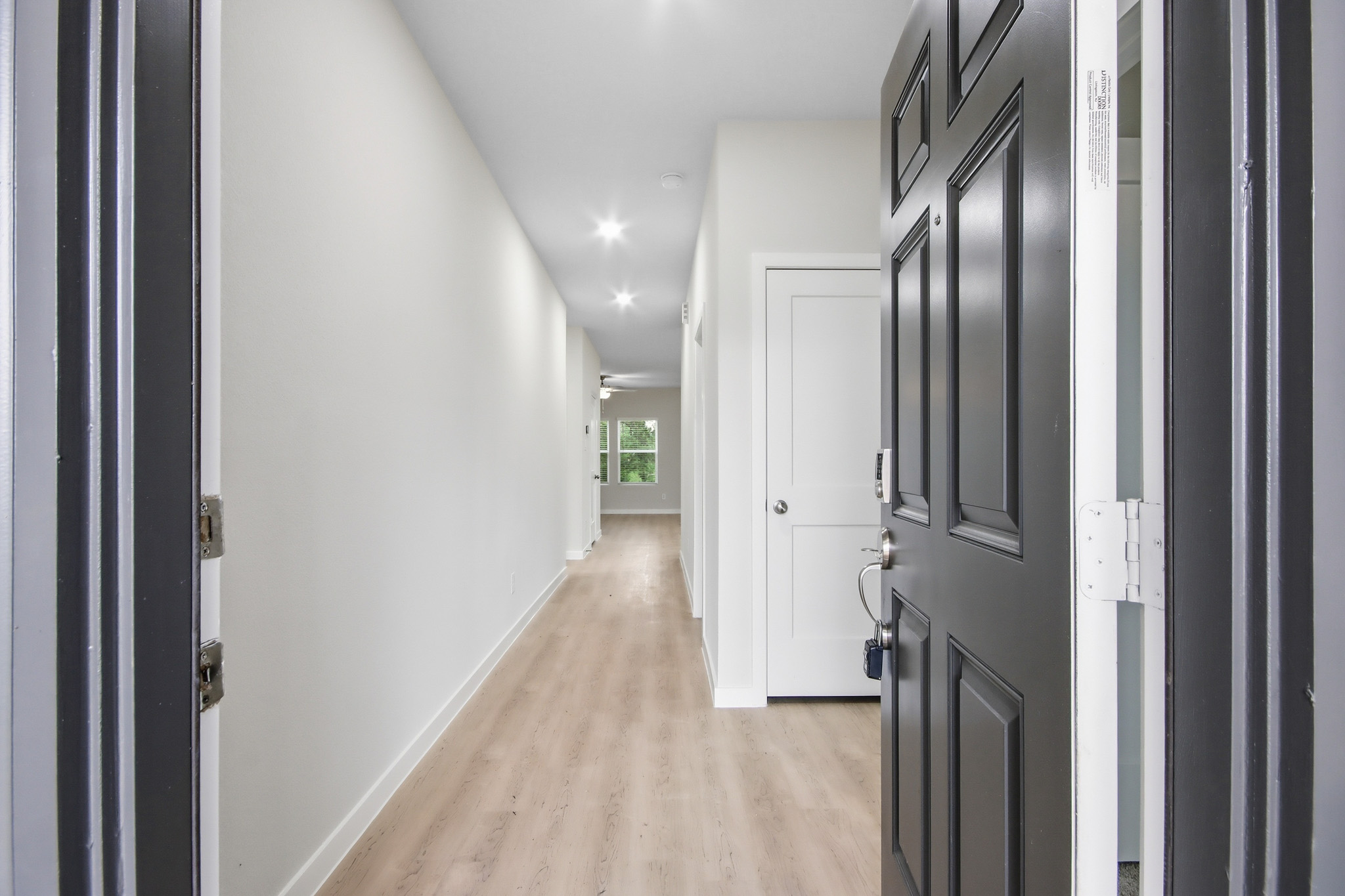 A hallway with black doors.