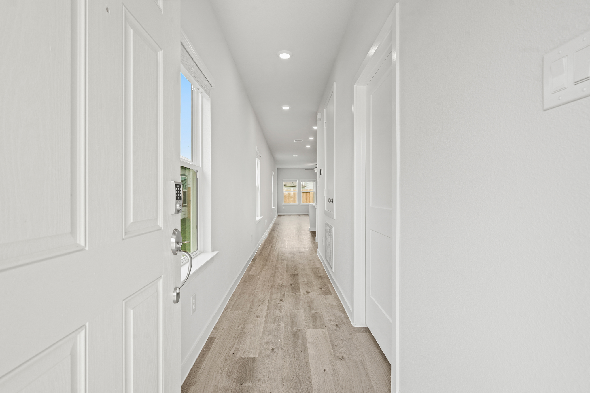 A hallway with white doors.