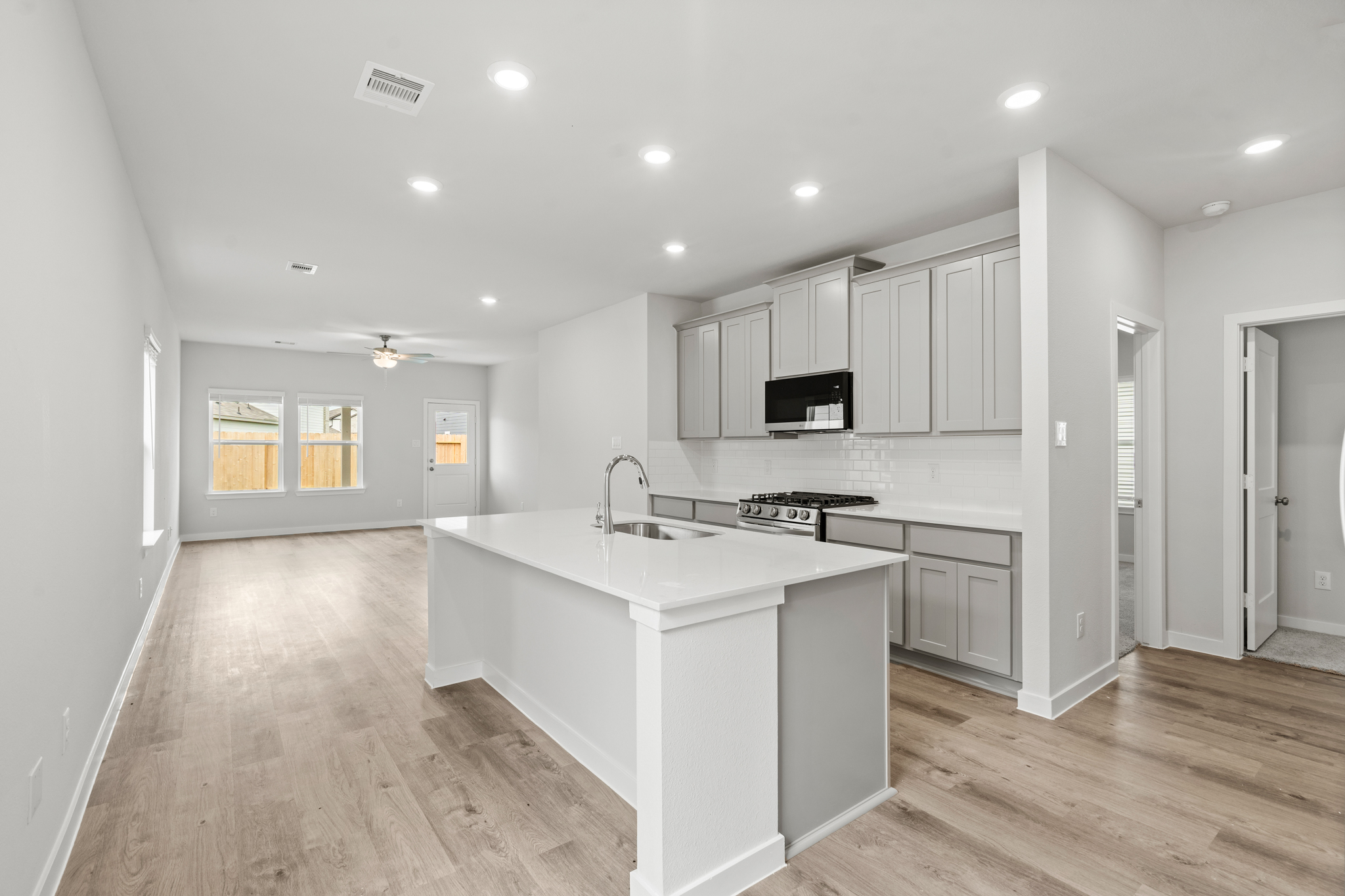 A kitchen with white cabinets.