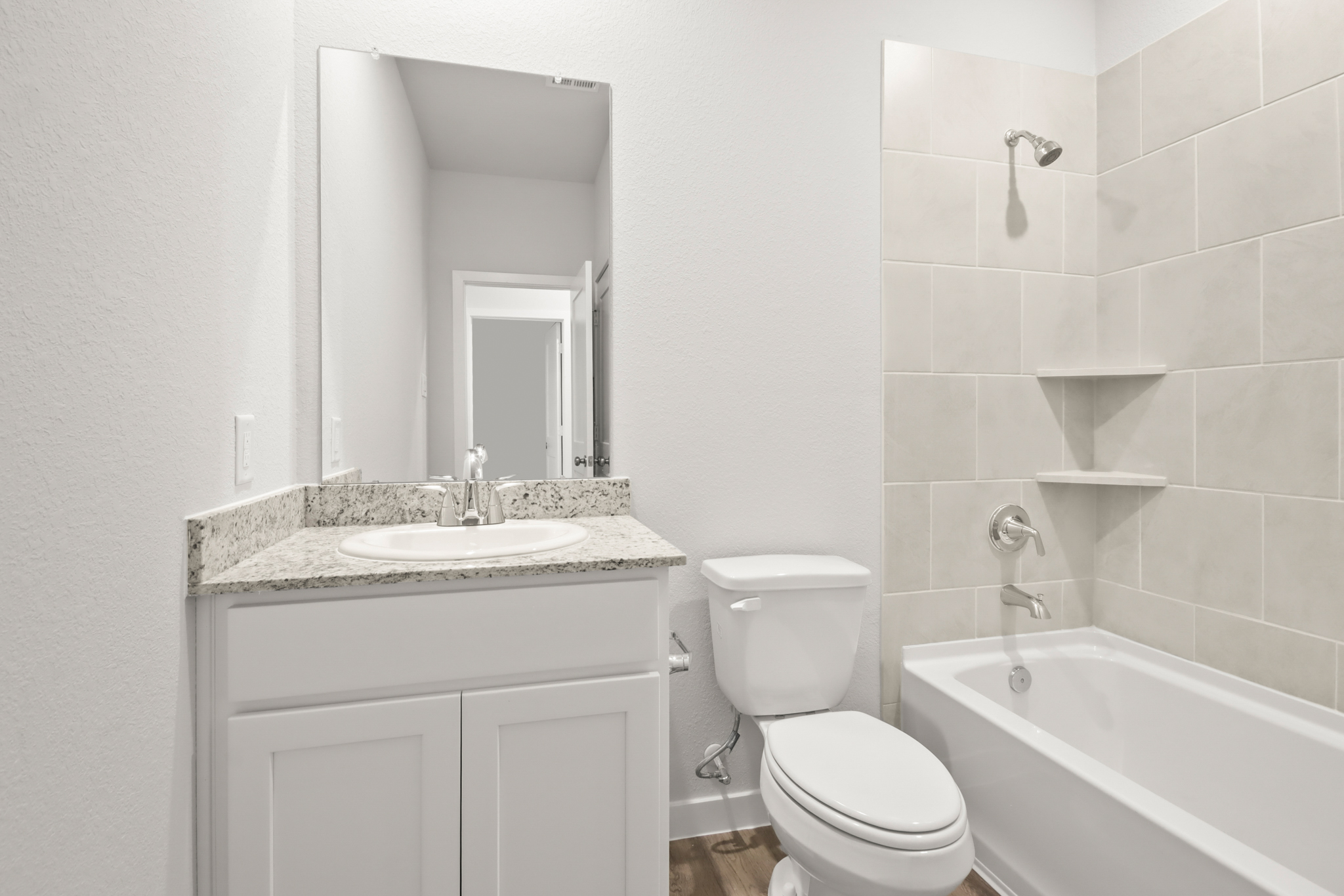 A bathroom with a sink toilet and bathtub.