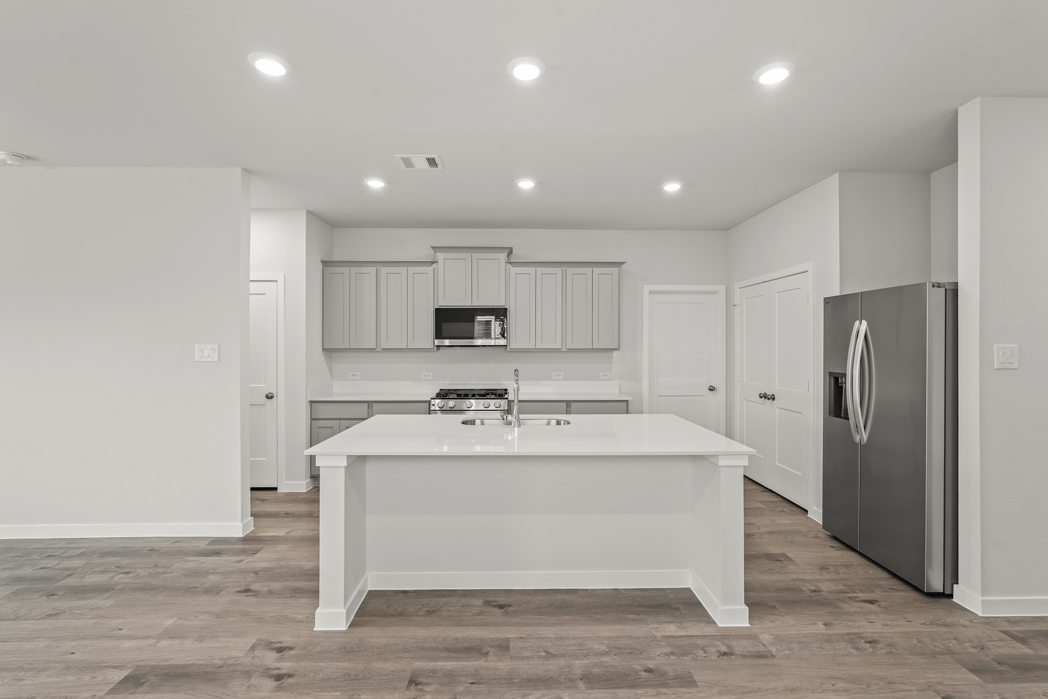 A kitchen with white cabinets.