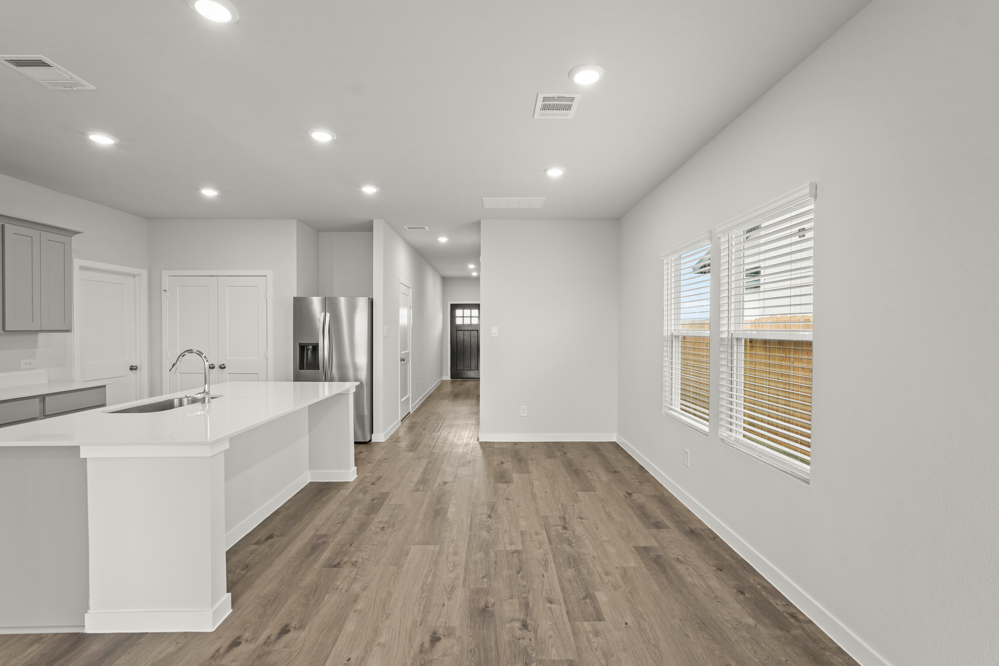 A kitchen with white cabinets.