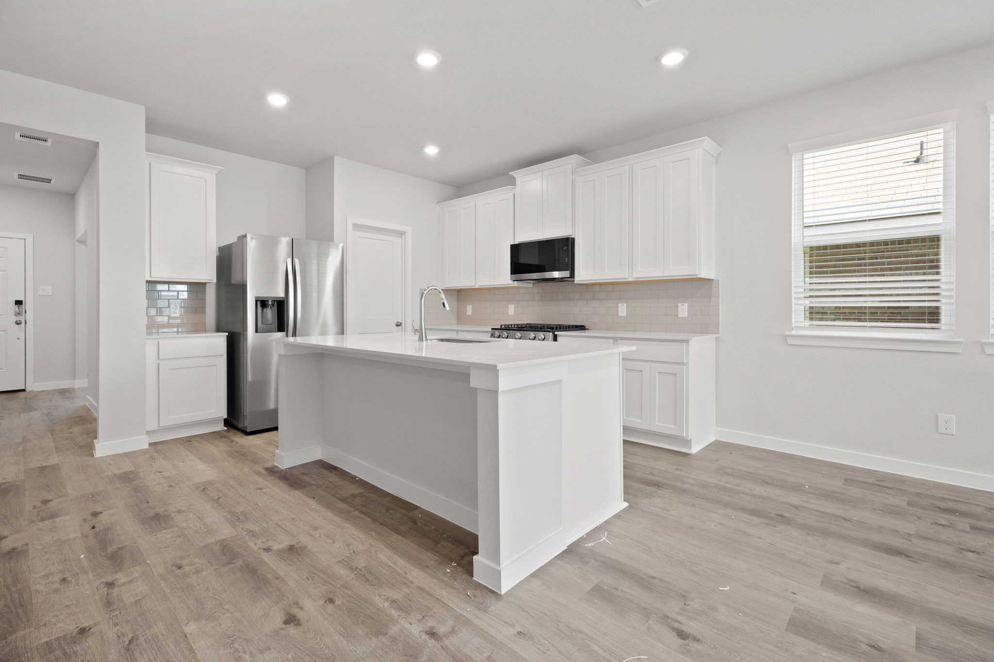 A kitchen with white cabinets.