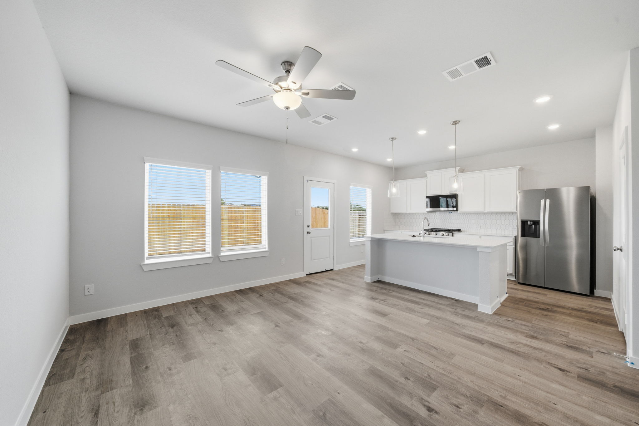 A kitchen with white cabinets.