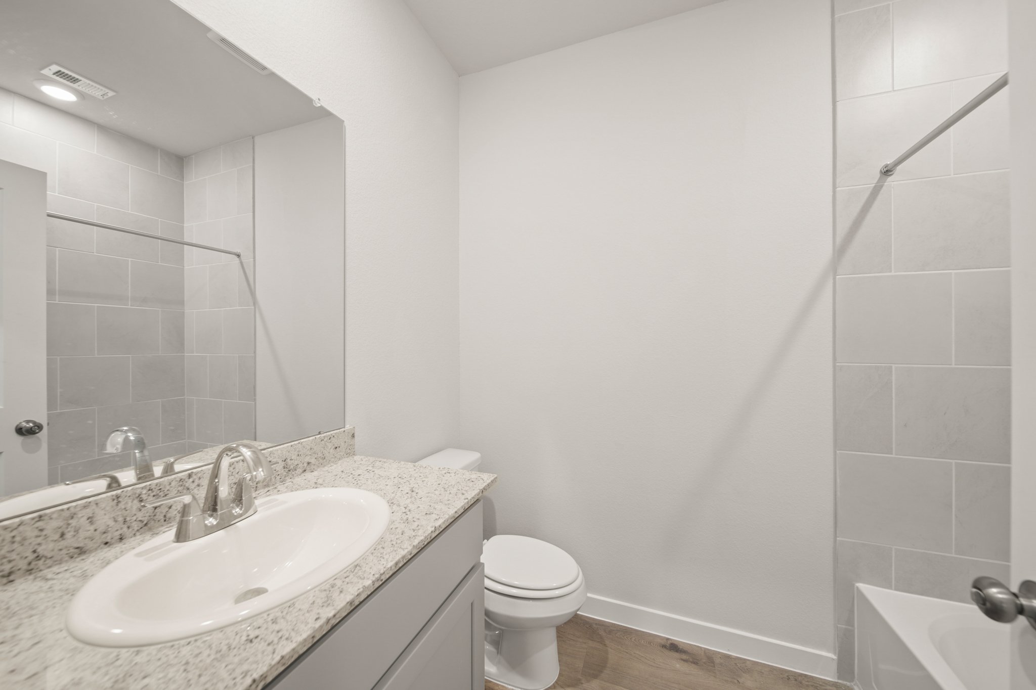 A bathroom with a sink and a toilet.