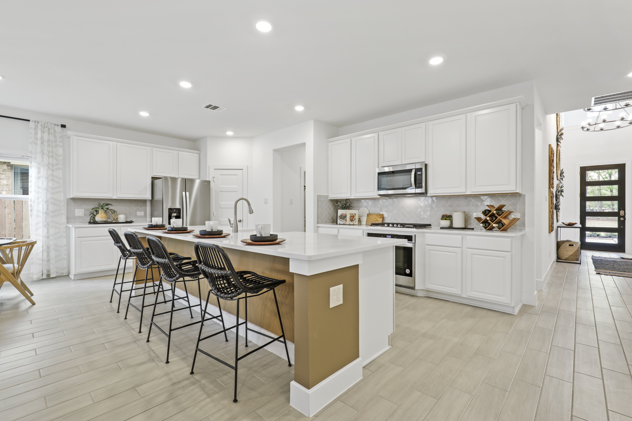 A kitchen with white cabinets.