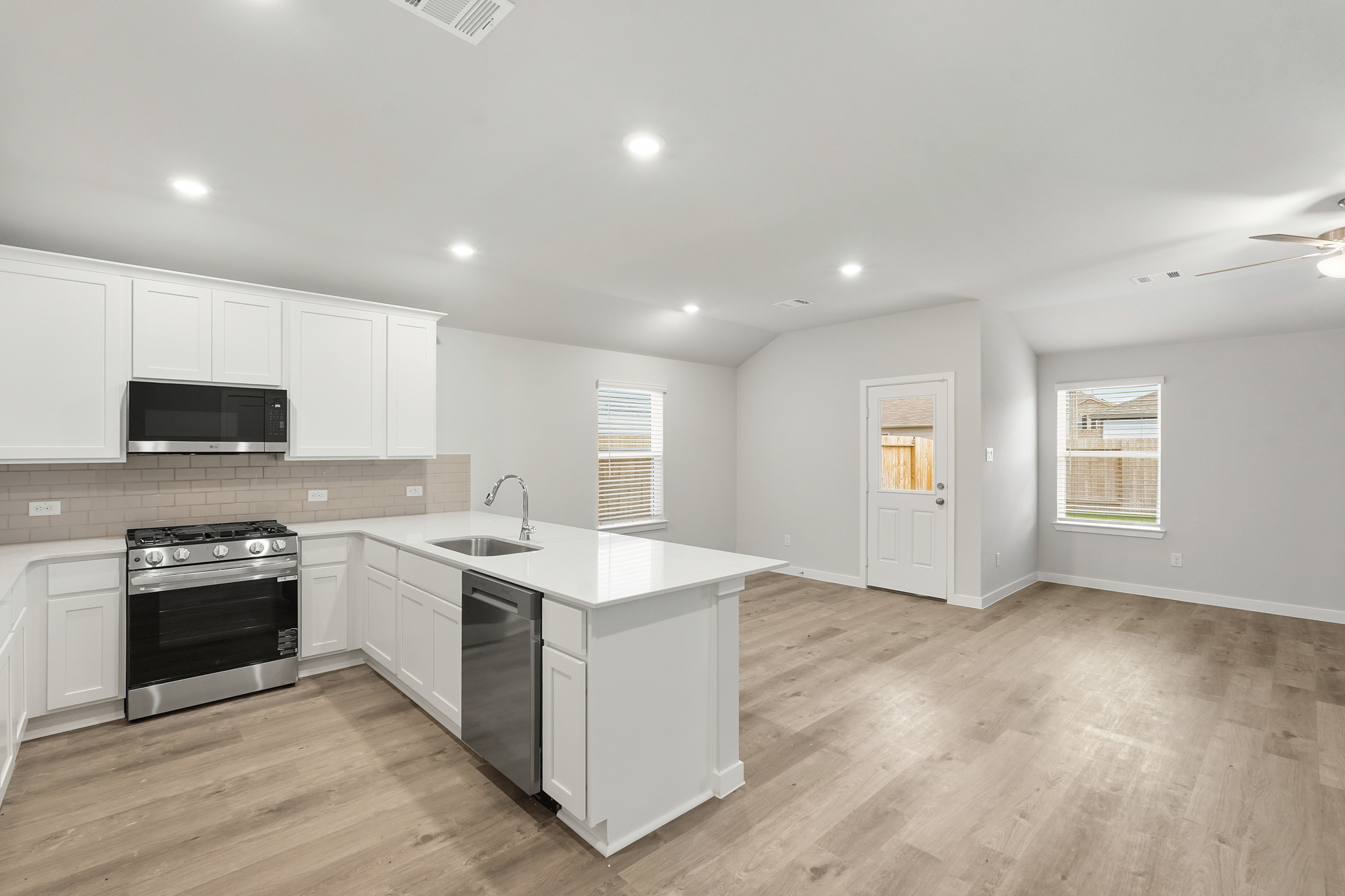 A kitchen with white cabinets.