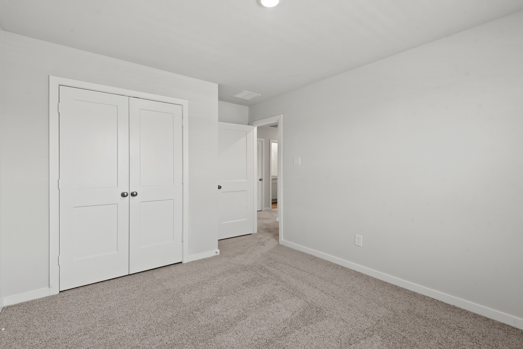 A hallway with white doors.