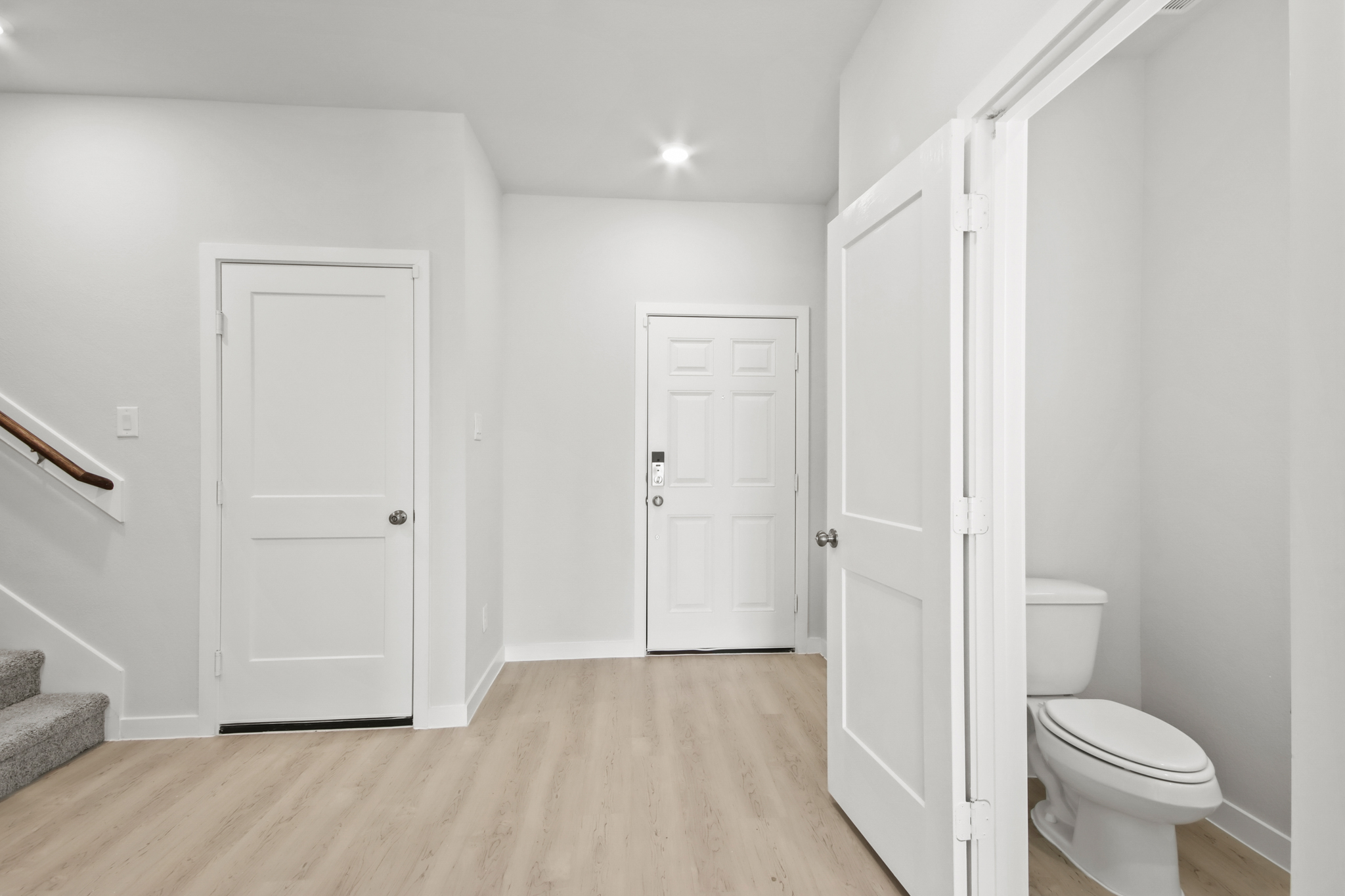 A bathroom with white doors.