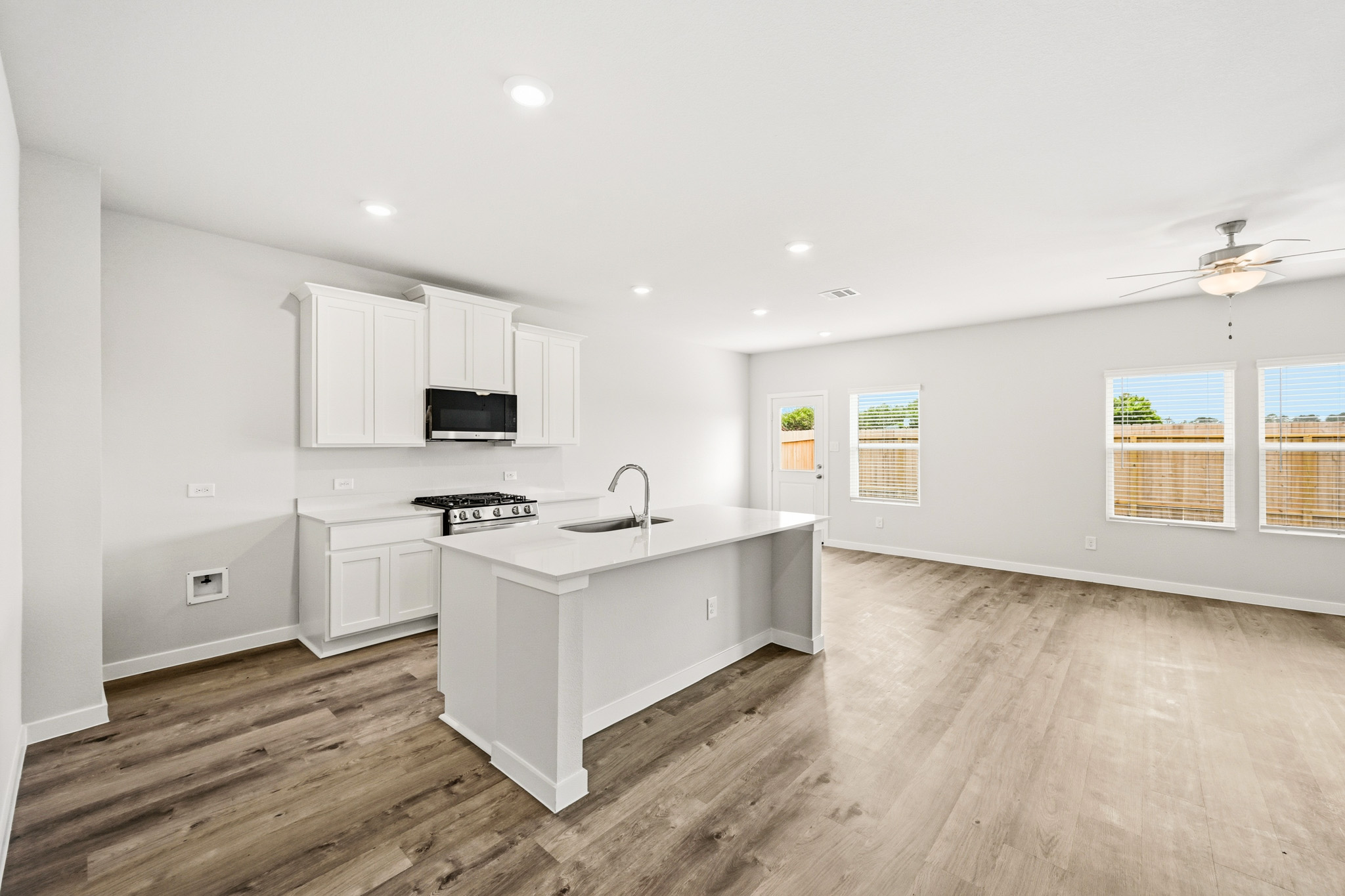 A kitchen with white cabinets.