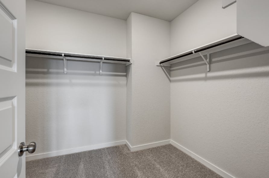 A white room with a metal railing.