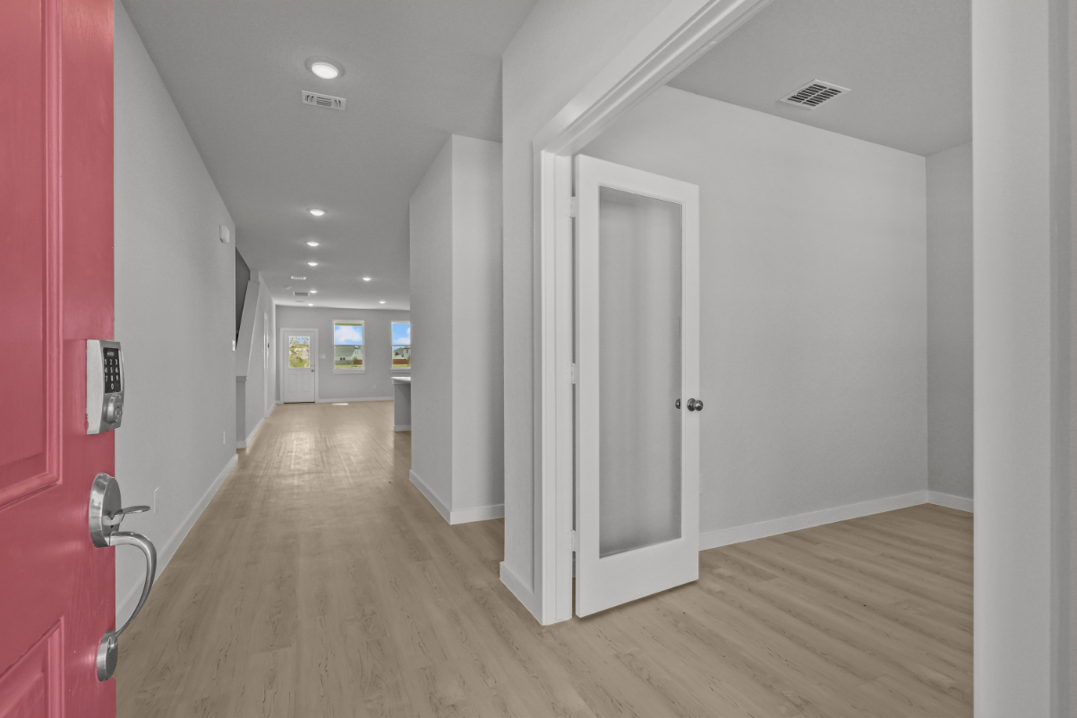 A hallway with white doors.