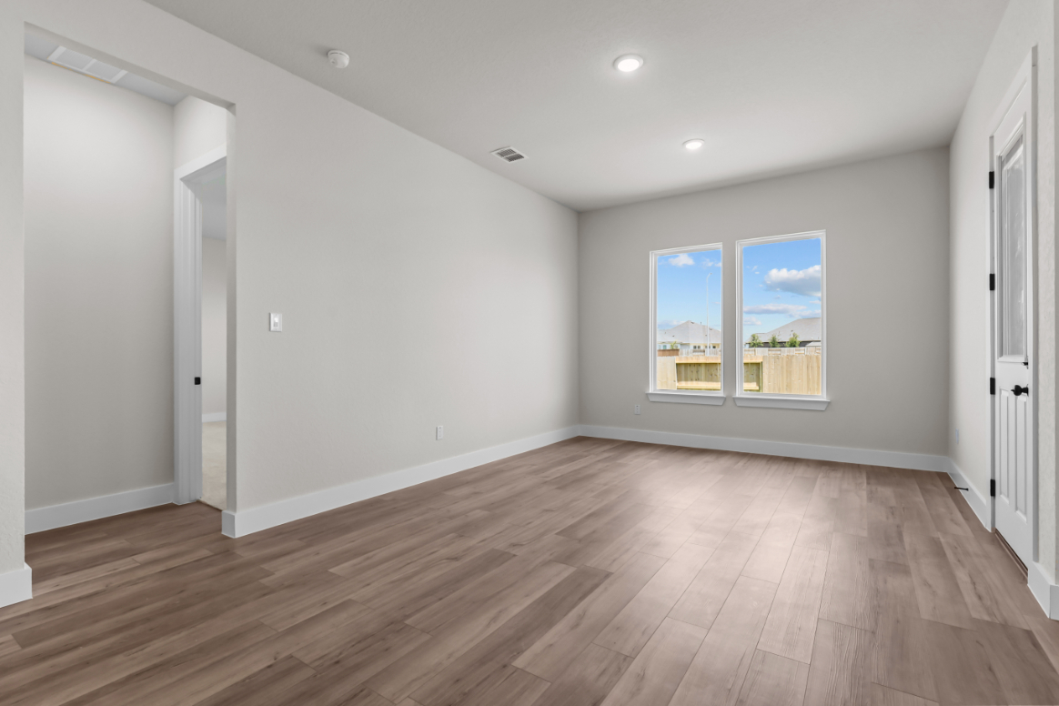 A room with a wood floor and a wood floor with a window.