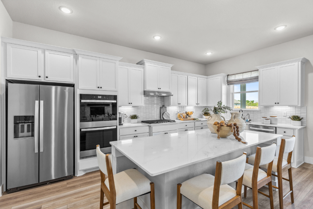 A kitchen with white cabinets.