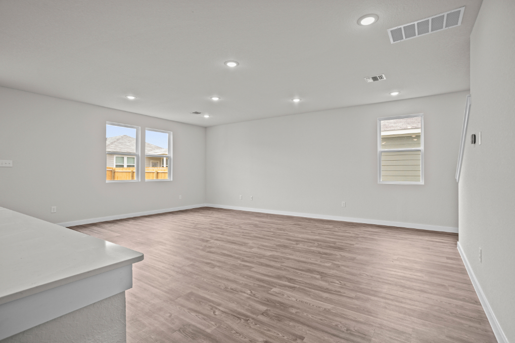 A room with a wood floor and a window.
