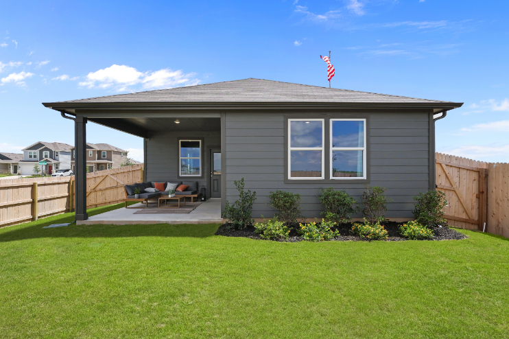 A house with a lawn and a fence.