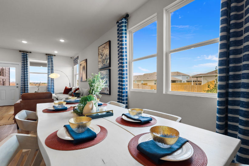 A dining room with a large window.