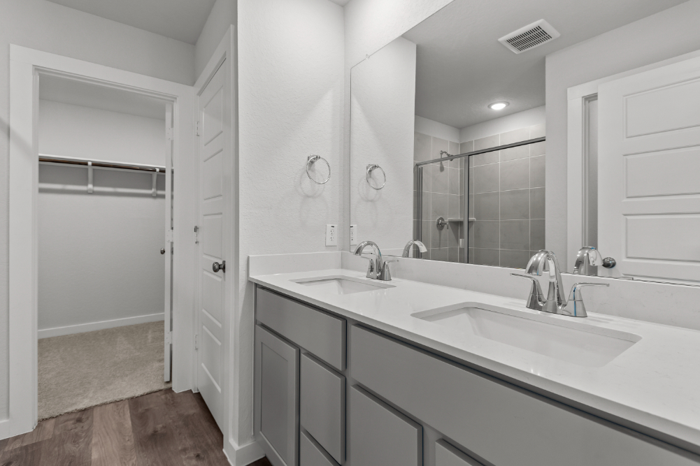 A bathroom with a large mirror.