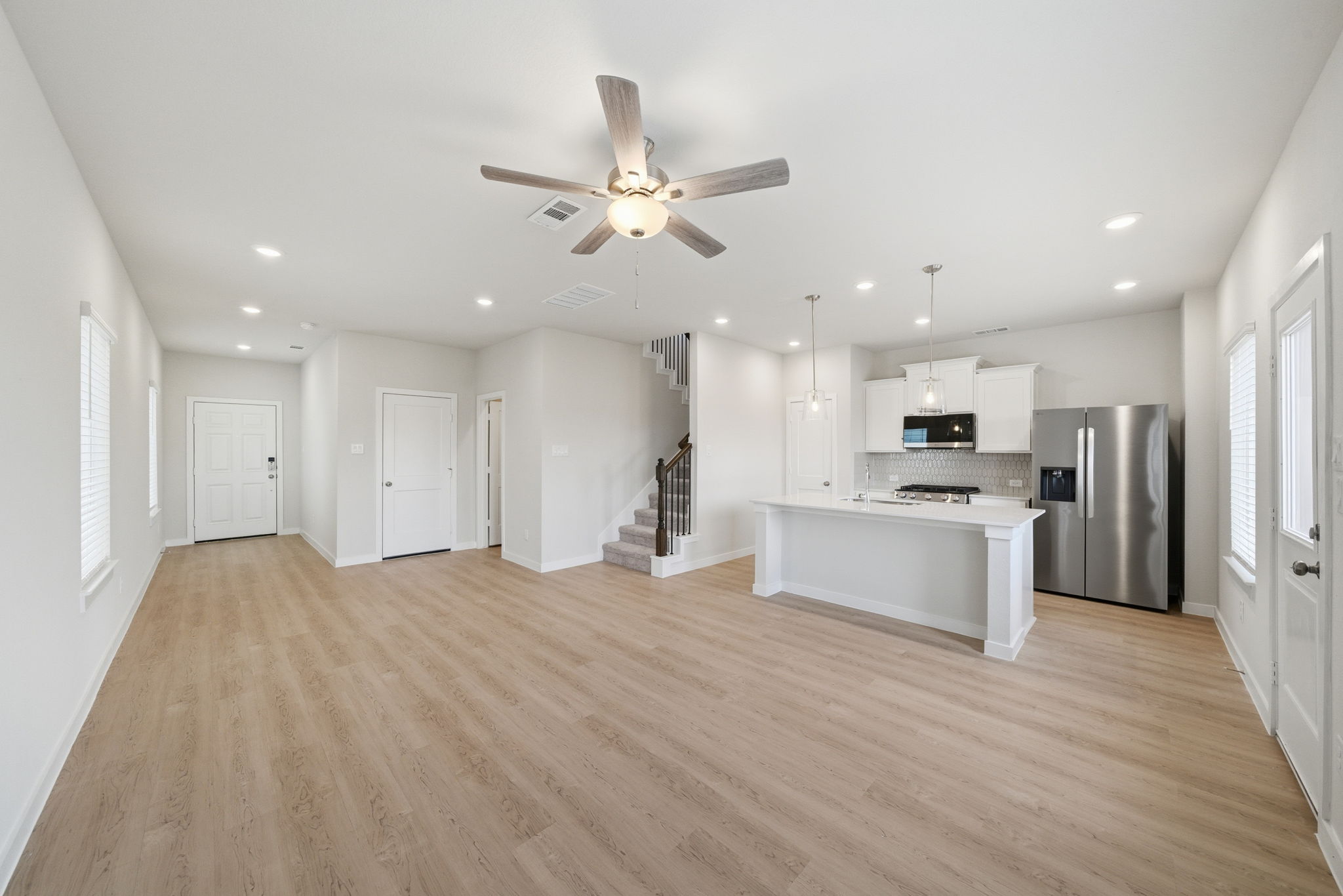 A large kitchen with a wood floor.