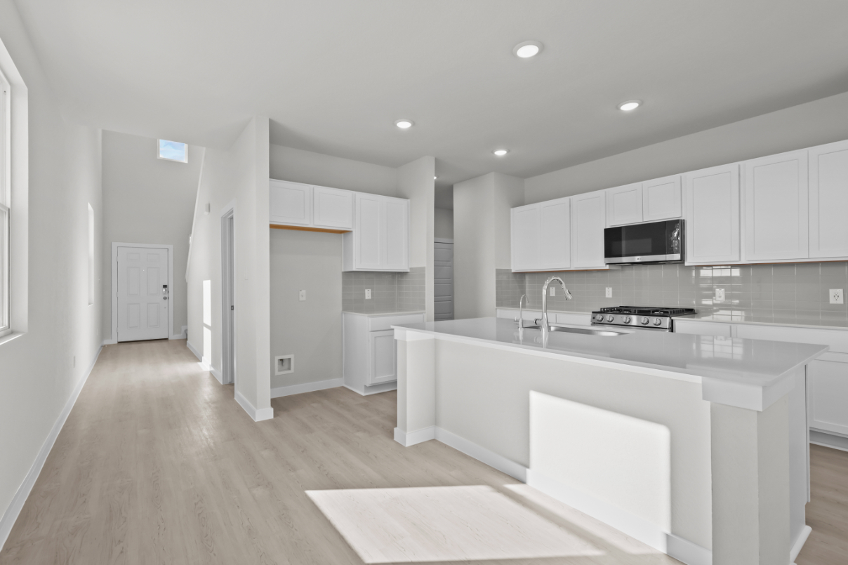 A kitchen with white cabinets.