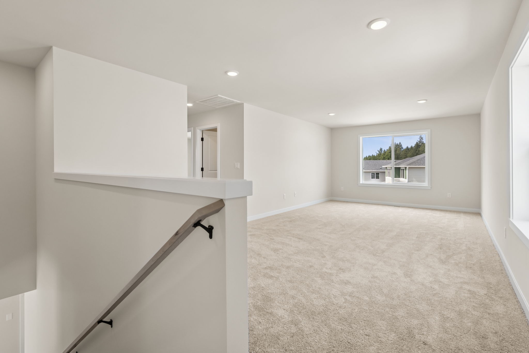 A room with a white wall and a window.