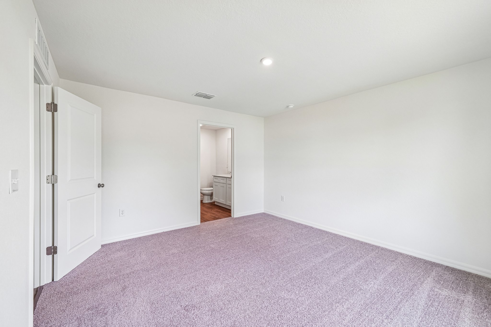 A hallway with white doors.