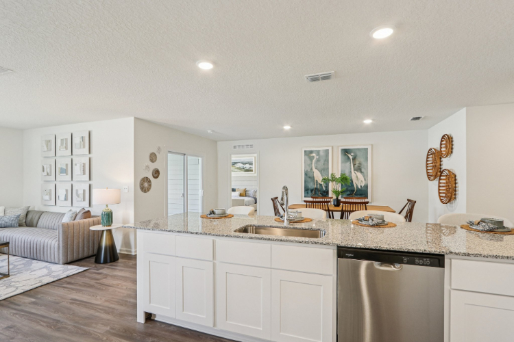 A kitchen with white cabinets.