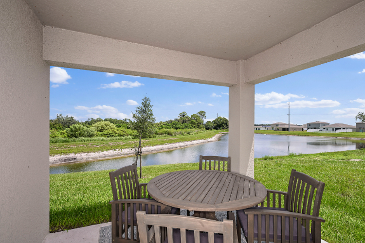 A table and chairs on a deck.