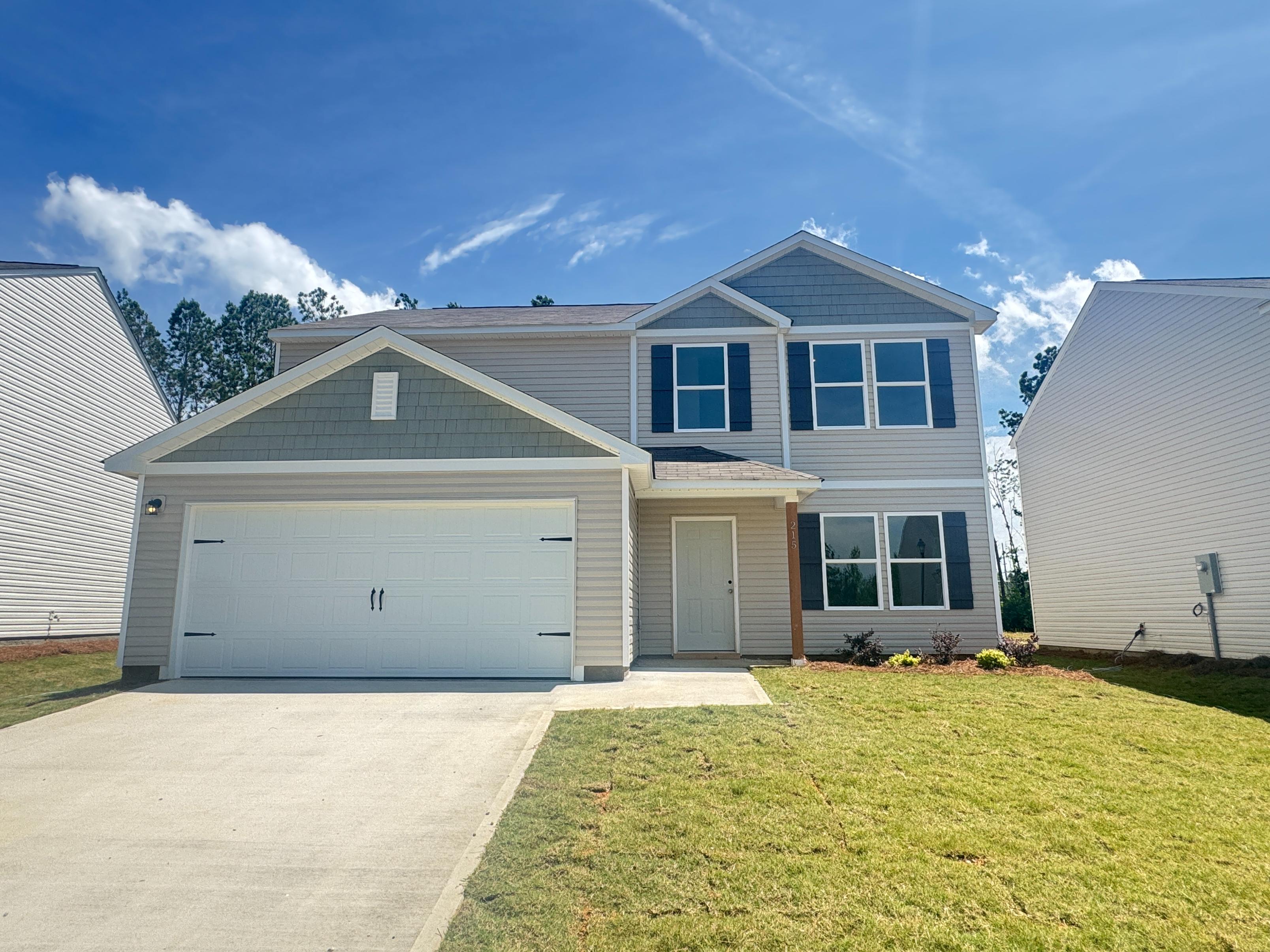 A house with garages and grass.