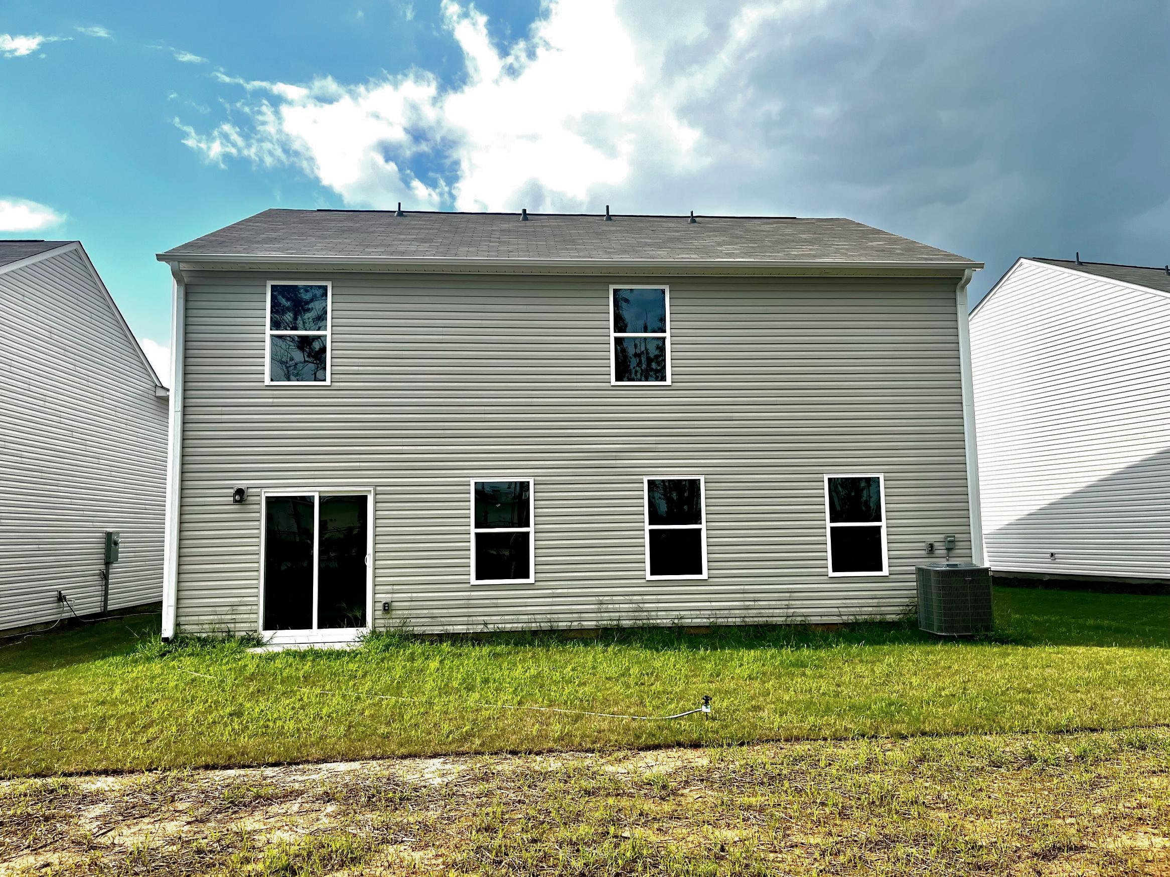 A grey house with windows.