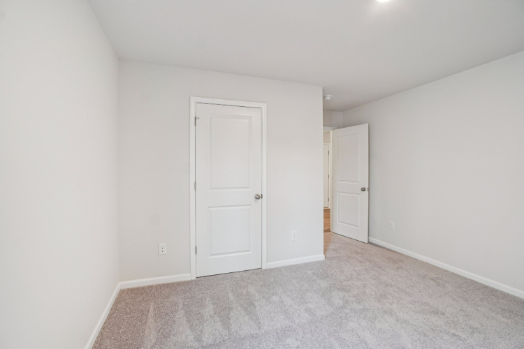 A hallway with white doors.
