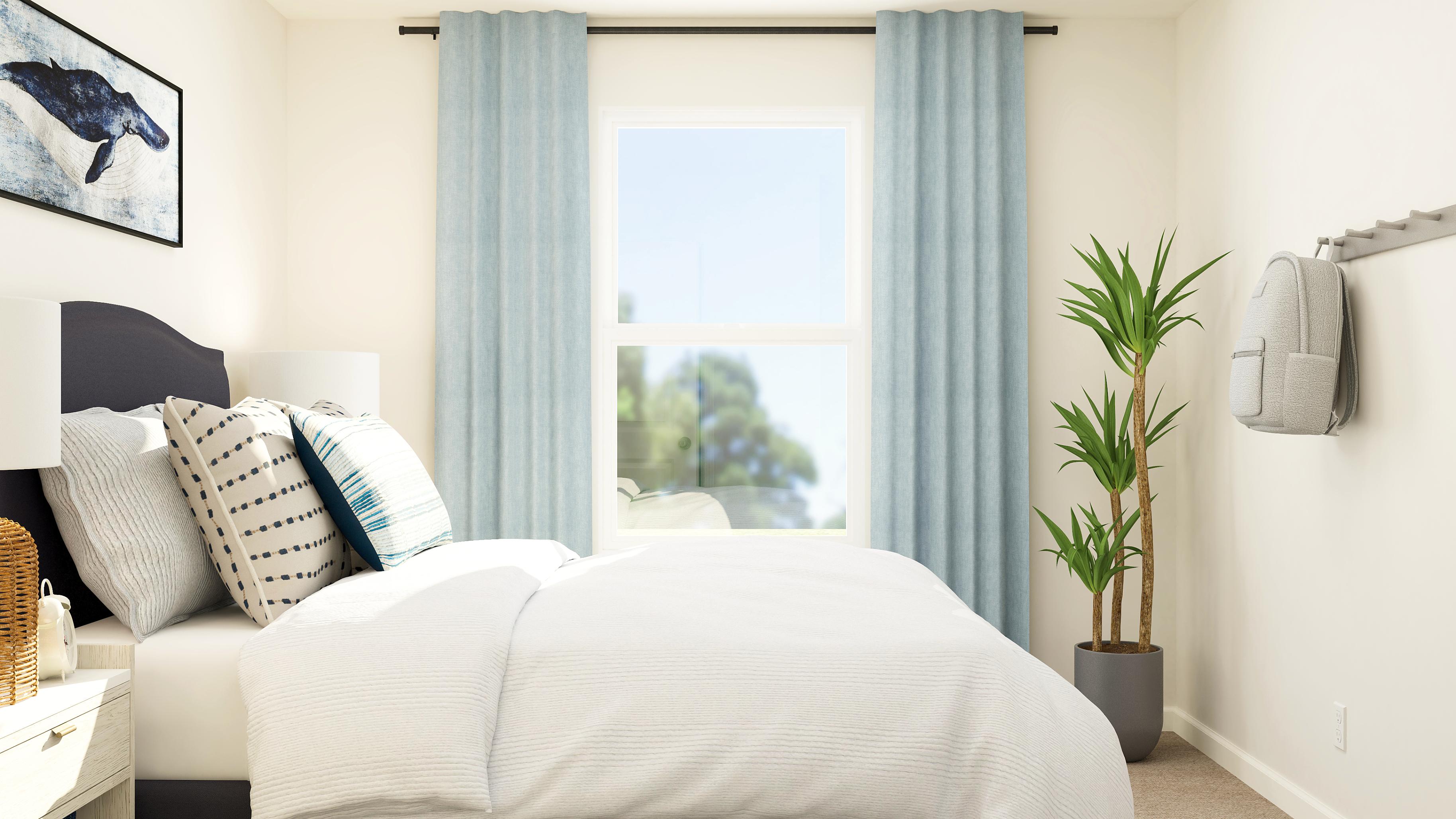 A couch with pillows and a plant.