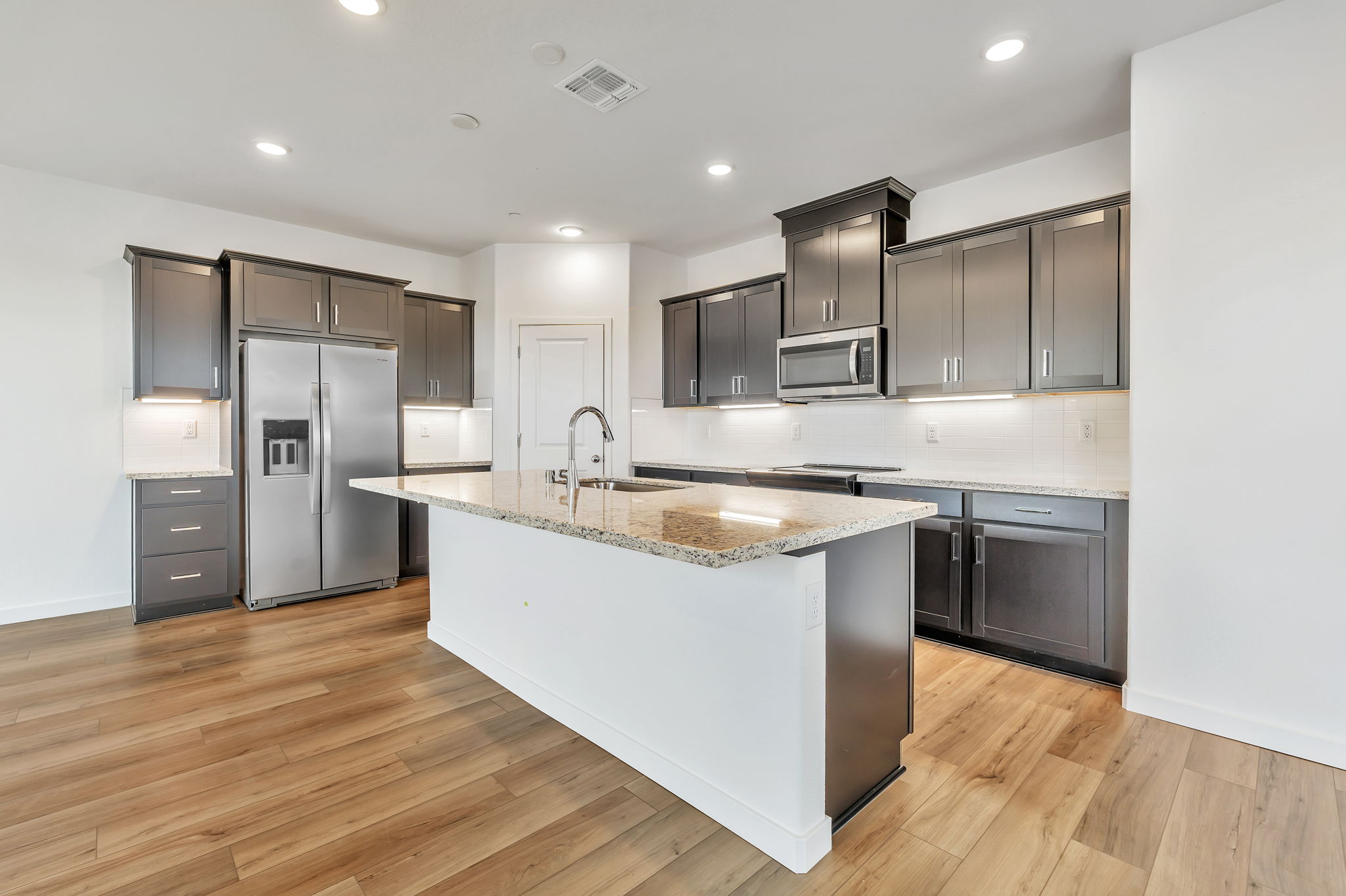 A kitchen with black cabinets.