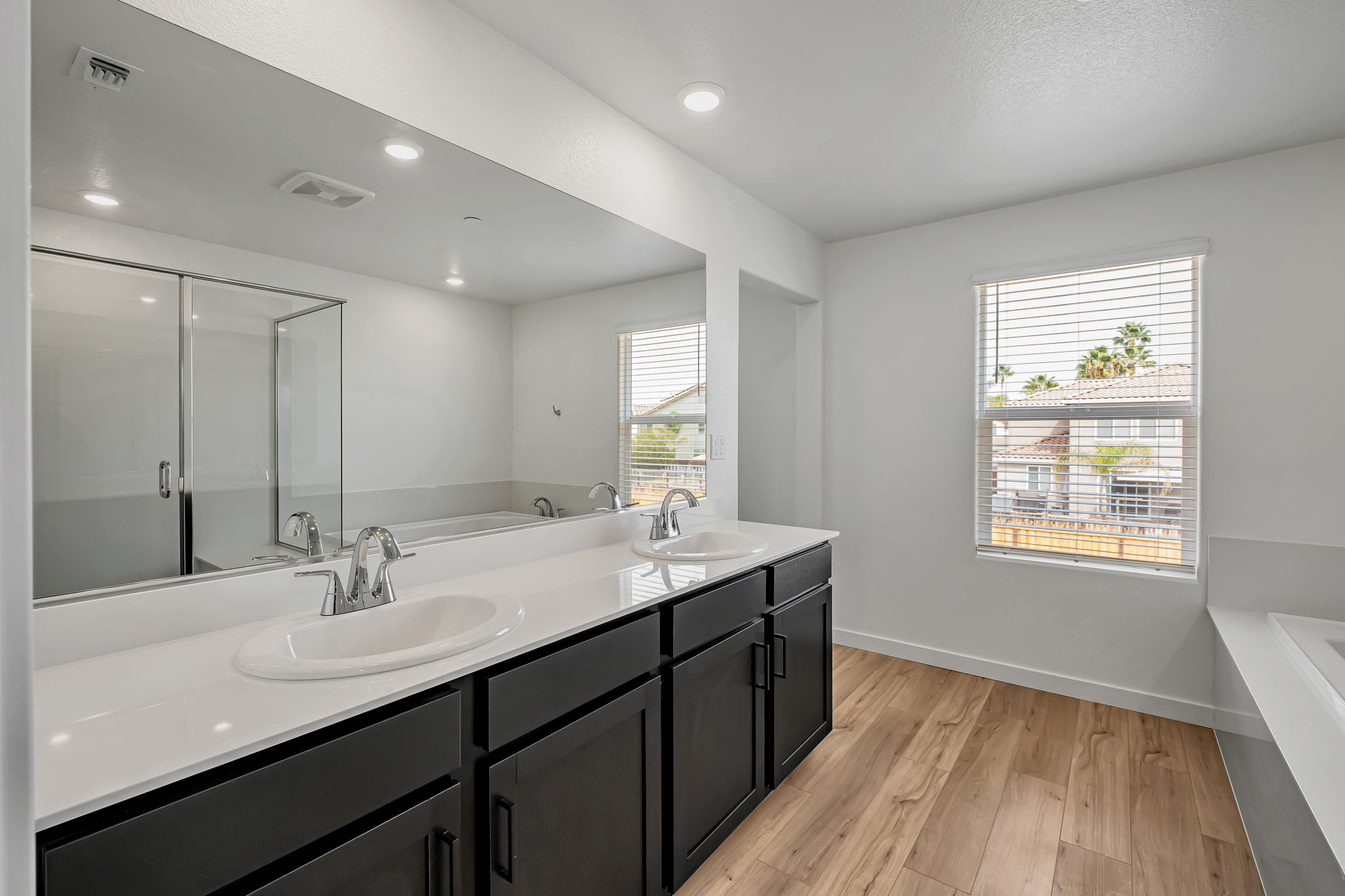 A bathroom with a large mirror.